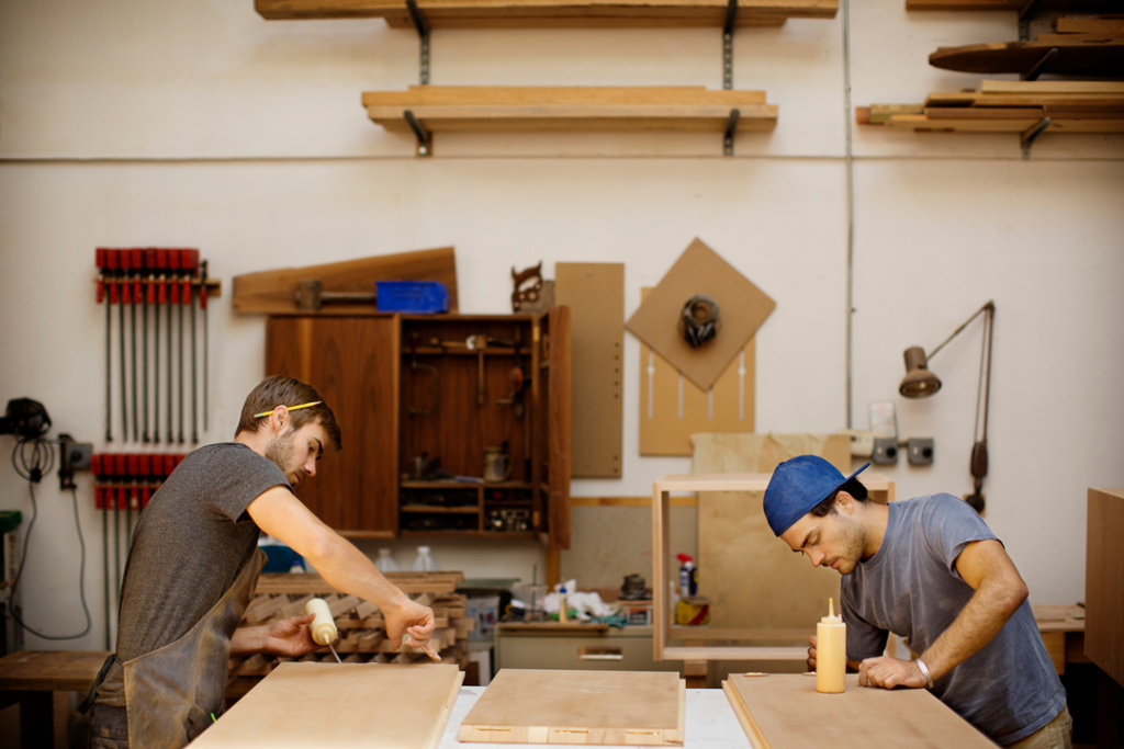 two men working in their wood shop 